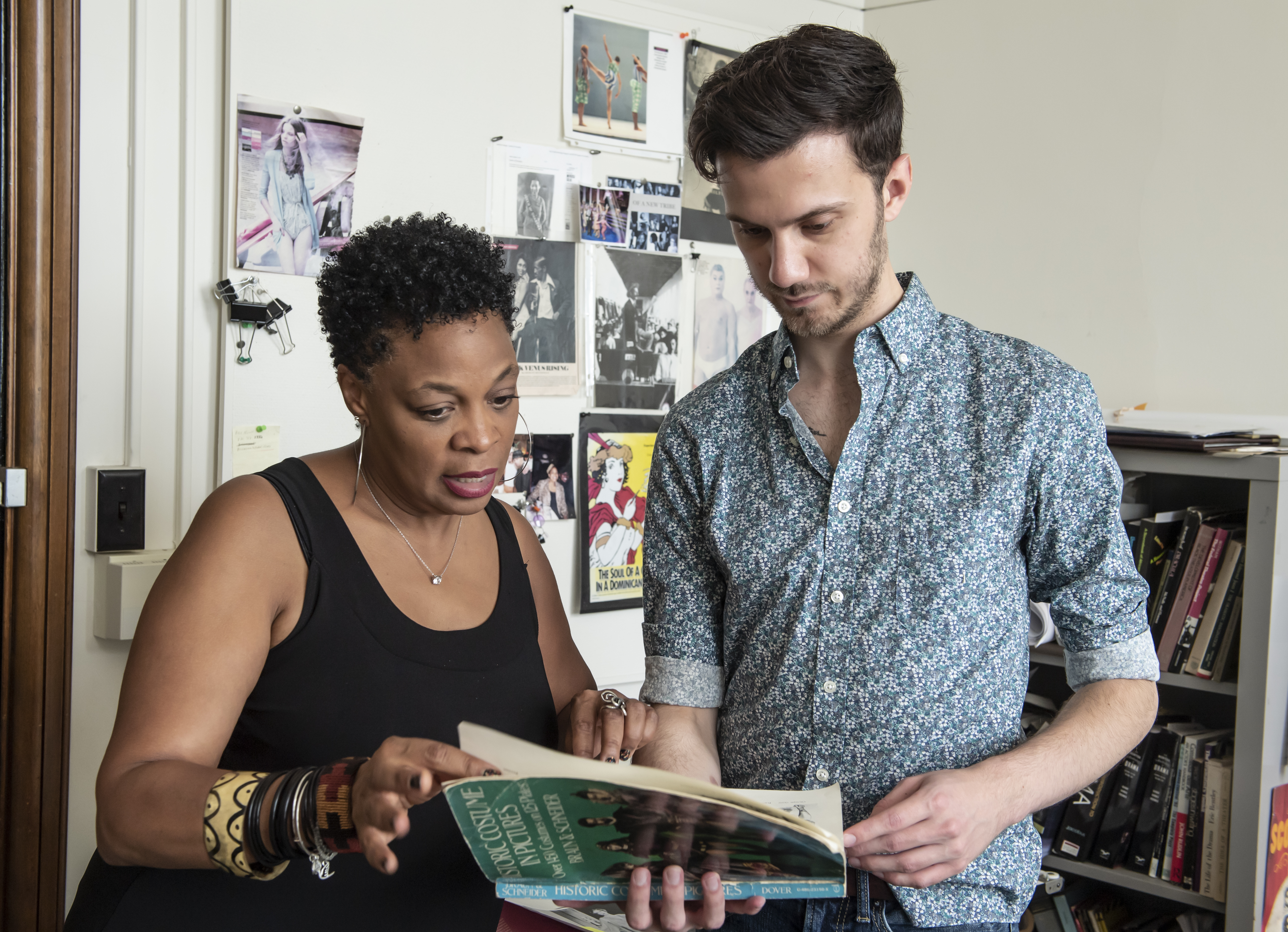 Faculty Karen Gilmer, Department of Theatre Arts with undergraduate student Kyle Huber, reviewing Huber's research project in the history of costume design in Gilmer's office.
